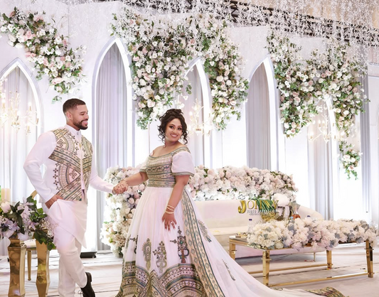 Bride and groom wearing matching traditional outfits, with the bride in a stunning Ethiopian wedding dress