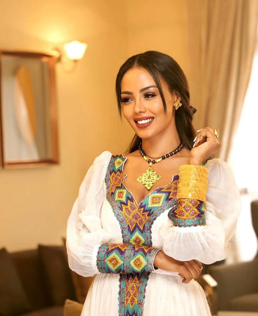 Elegant White Habesha Kemis - Modern Ethiopian Dress with Gold & Blue Embroidery Bezawit