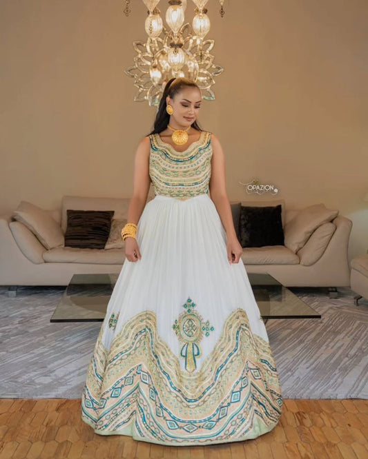 Woman in a Ethiopian Dress with intricate designs in a living room setting