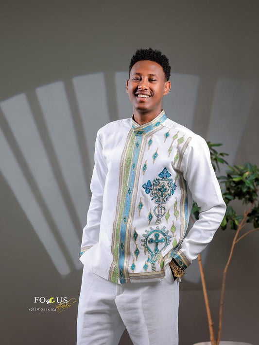Man wearing a Habesha Men’s Cultural Shirt with a neutral background