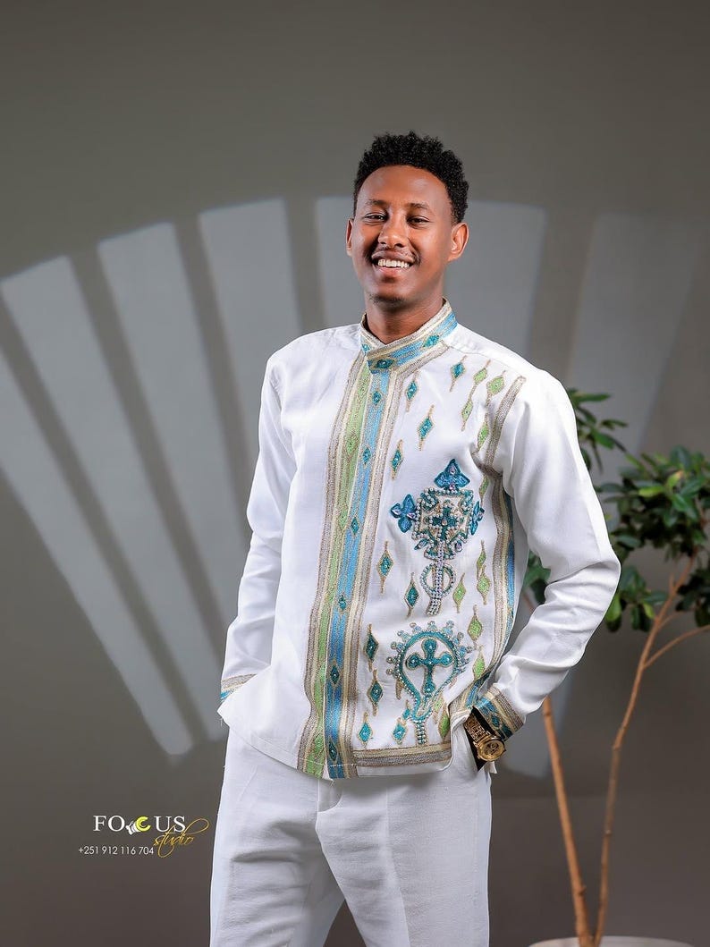 Man wearing a Habesha Men’s Cultural Shirt with a neutral background