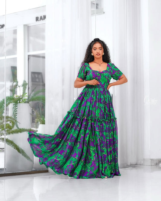 Woman wearing a green and purple Green Habesha Shifion in a modern indoor setting