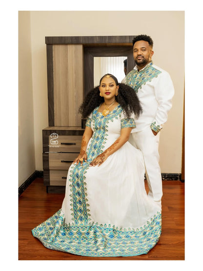 Man and woman in traditional attire sitting together in a room.