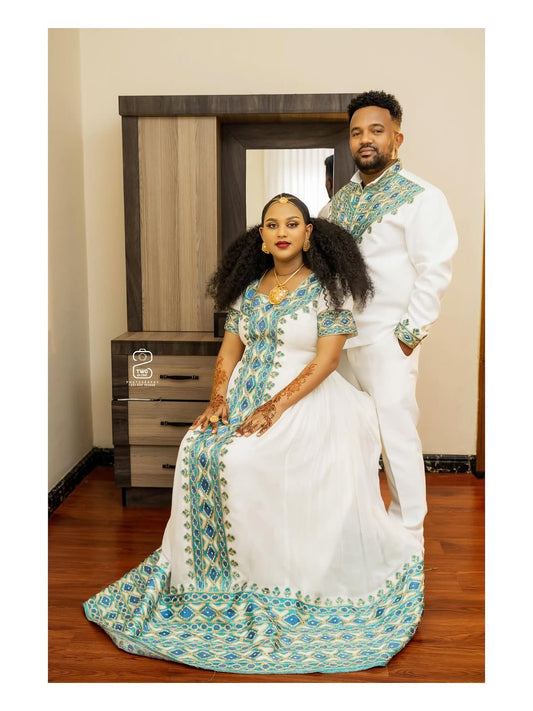 Man and woman in traditional attire sitting together in a room.