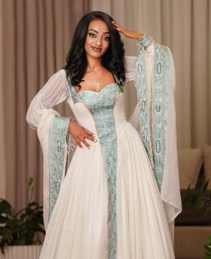 Modern Ethiopian Dress for Celebrations- Flowing White Habesha Dress with Green Tibeb-Inspired Gown yaab.habesha