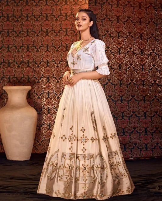 Golden Glamour: Elegant Ethiopian Dress with Intricate silver Detailing