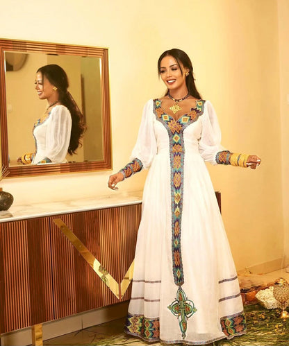 Elegant White Habesha Kemis - Modern Ethiopian Dress with Gold & Blue Embroidery Bezawit