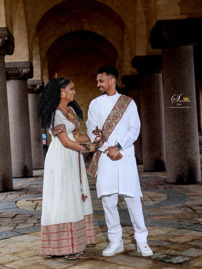 Couple in traditional Red Matching Habesha Set  standing in an archway