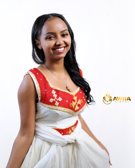 Woman wearing a traditional Red Habesha Libs  with red and white colors on a white background