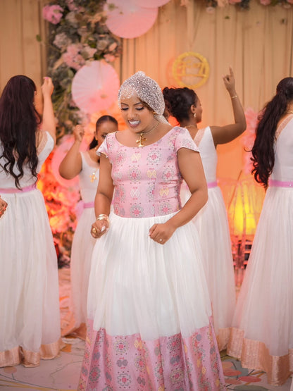 Woman in a floral habesha wedding dress with a floral backdrop and other women in matching dresses.
