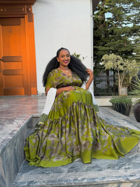 Woman in a green dress sitting on steps outdoors