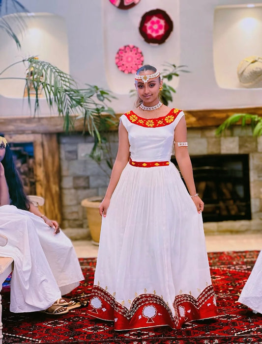 ኤርትራ ልብስ – ቀይ ቀሚስ በብርማ የእጅ ጥልፍ የተዋበ