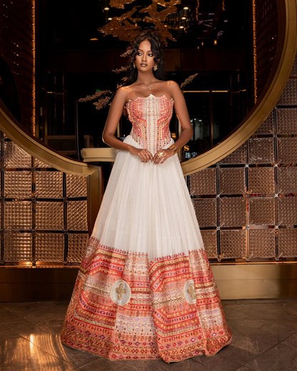 Woman wearing a traditional Ethiopian traditional dress  with intricate patterns in a decorative setting