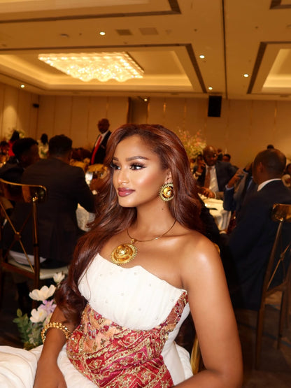 Woman in a formal Ethiopian Traditional Dress with intricate design at an event