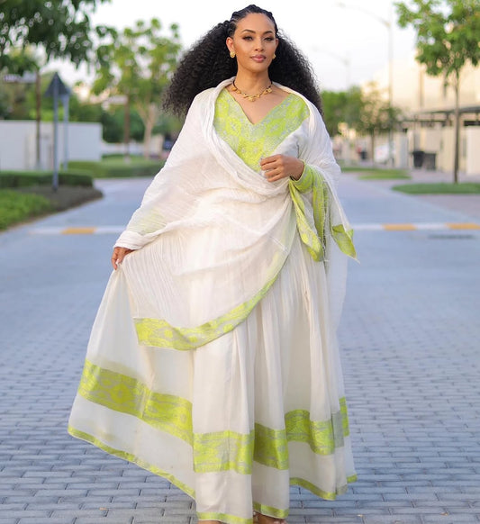 Woman wearing a white and green Habesha Dress saree on a street