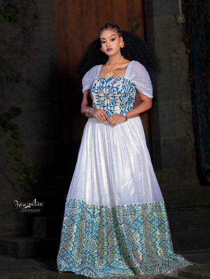 Woman wearing a Ethiopian traditional dress with a blue and white patterned dress.
