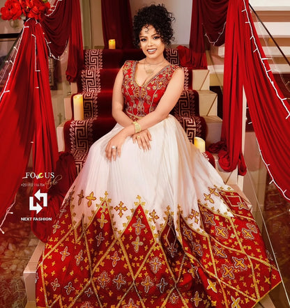 Woman in a red and Ethiopian Bridal Dress embroidered traditional outfit sitting on a decorated chair.