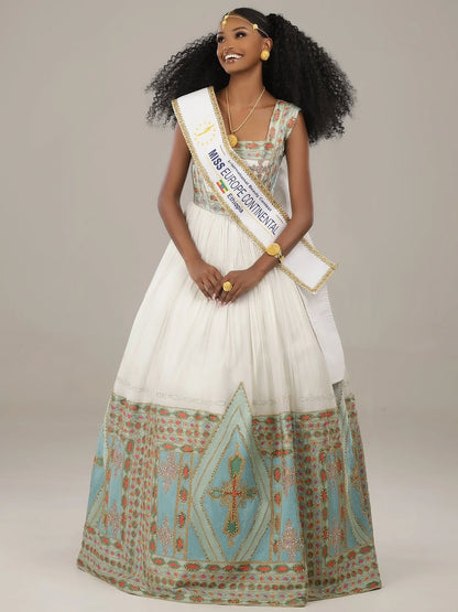 Woman in a formal Eritrean Libs  holding a sash with 'Miss Euphoria Centennial' on a plain background