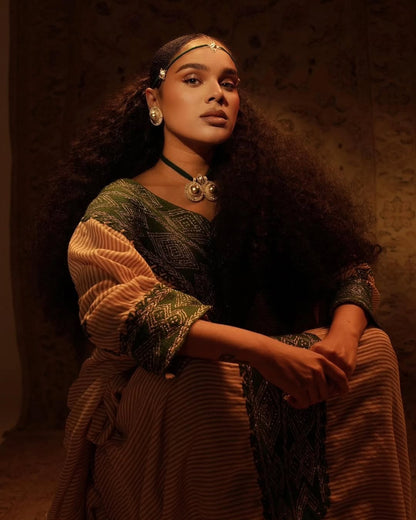 Woman in Gondar Fetel attire with a warm, brownish background