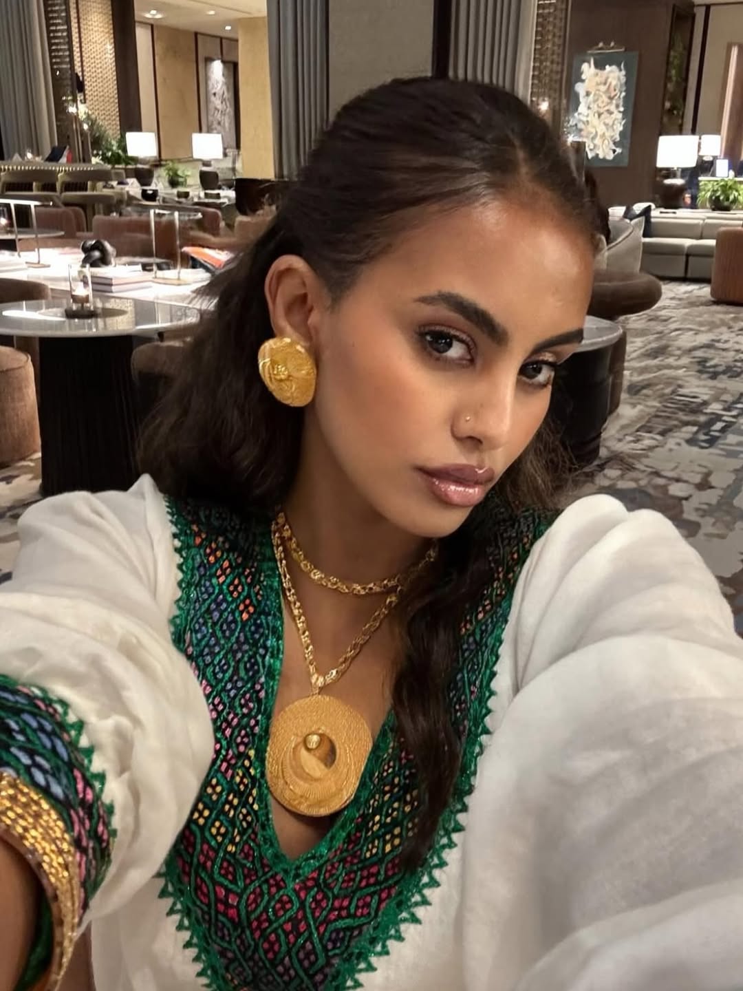 Woman wearing Ethiopian traditional dress in a hotel lobby