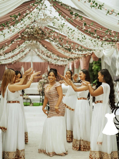 Group of women in white and gold Habesha Wedding Dress standing under a decorated tent.