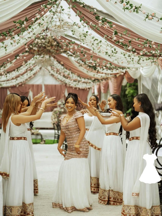 Group of women in white and gold Habesha Wedding Dress standing under a decorated tent.