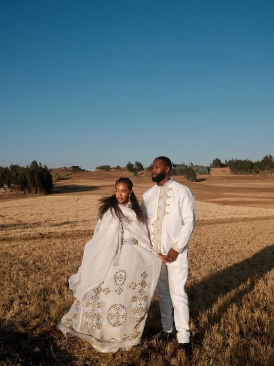 Couple in formal Matching couple Outfit set  standing in a field with a clear blue sky.