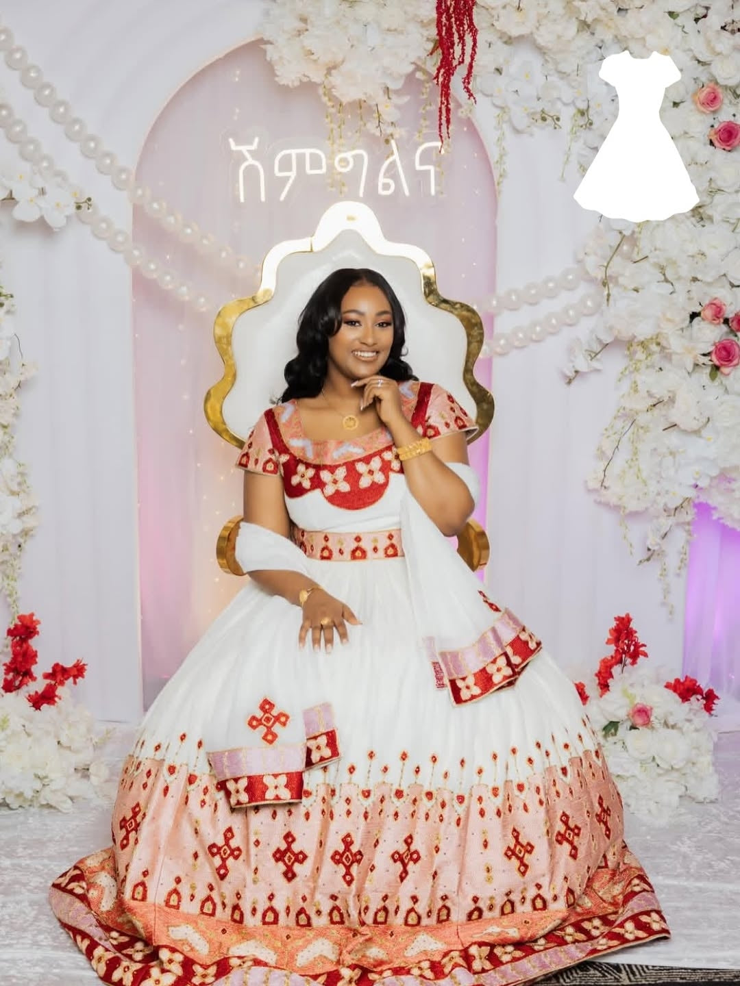 Woman in a red and white  Matching Habesha Outfit with floral decorations in the background
