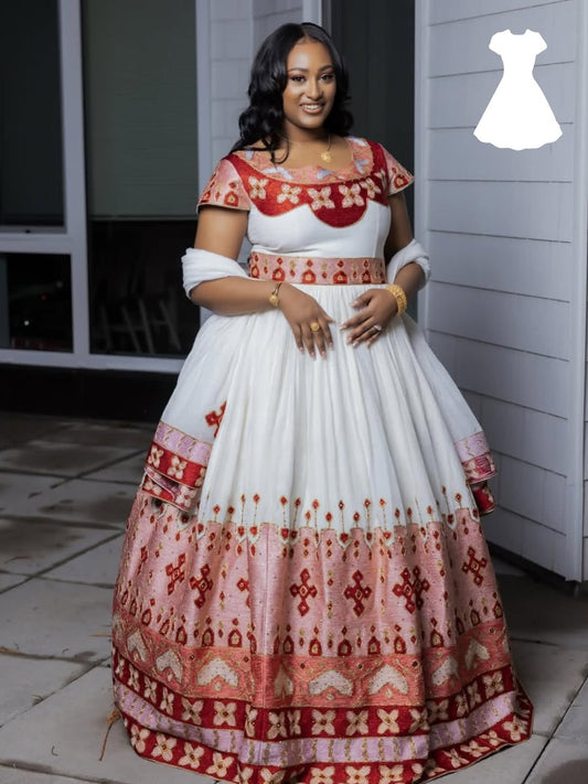 Woman wearing a white and red patterned  Matching Habesha Outfit standing outdoors.