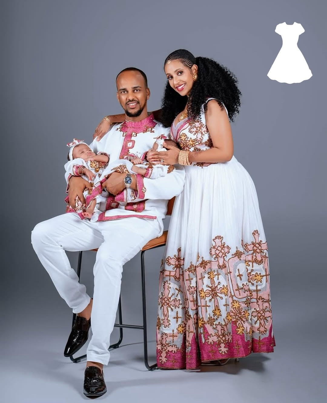 Family of three posing together with Matching Couple Set and a gray background
