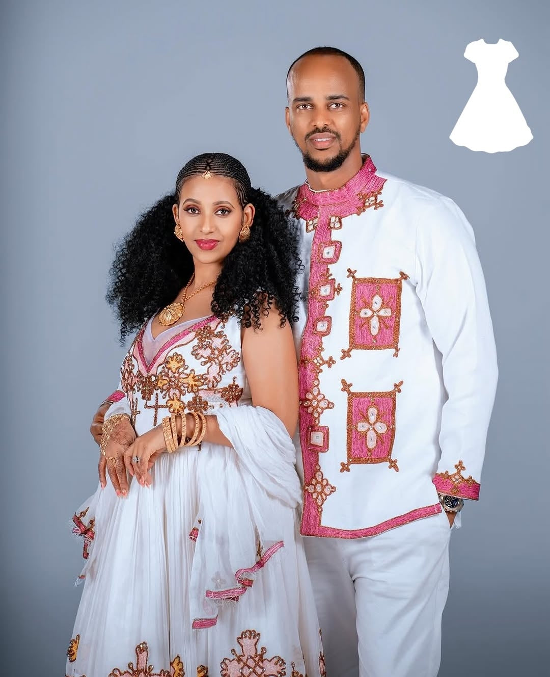 Couple wearing Matching Couple Set embroidered outfits on a gray background