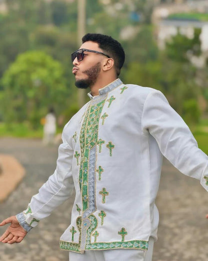 Man wearing Men’s Habesha Shirt embroidered shirt with green patterns outdoors