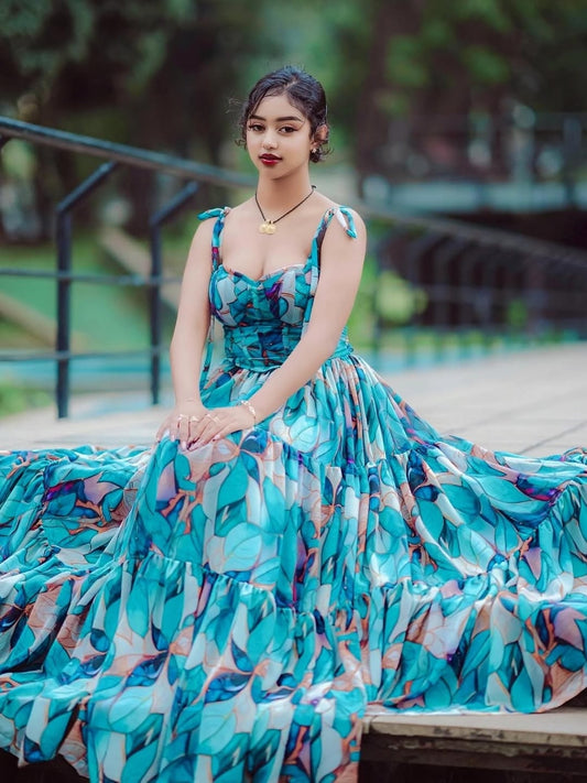 Woman in a blue floral Habesha Shiffon sitting outdoors with blurred background