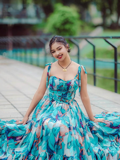 Woman in a colorful Habesha Shiffon sitting on a wooden bridge with greenery in the background