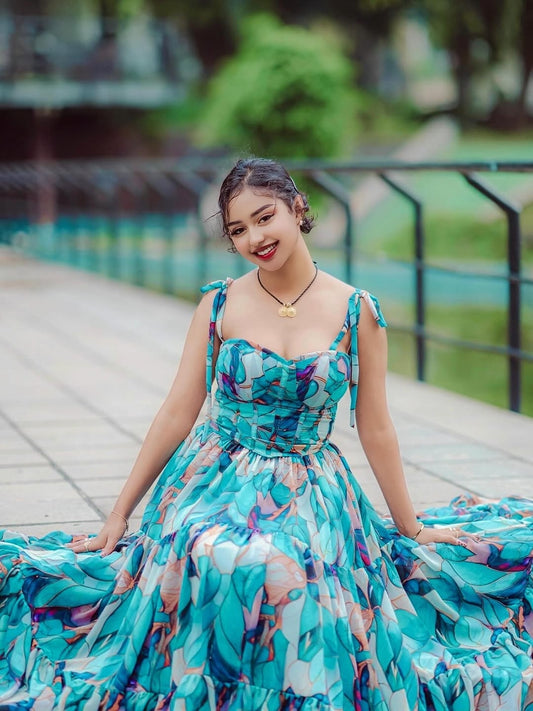 Woman in a colorful Habesha Shiffon sitting on a wooden bridge with greenery in the background