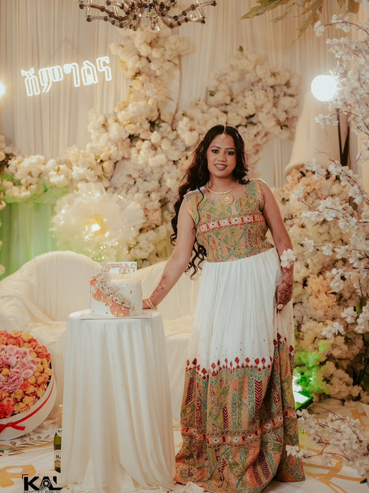 Woman in a decorated indoor setting with floral arrangements andRed Luxury Habesha Wedding Dress.