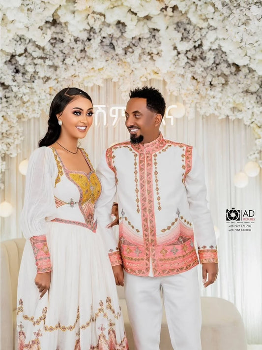 Ethiopian Habesha Couple Set in formal attire standing in front of a floral backdrop