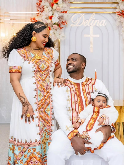 Family of three in matching Habesha Dress outfits with decorative background