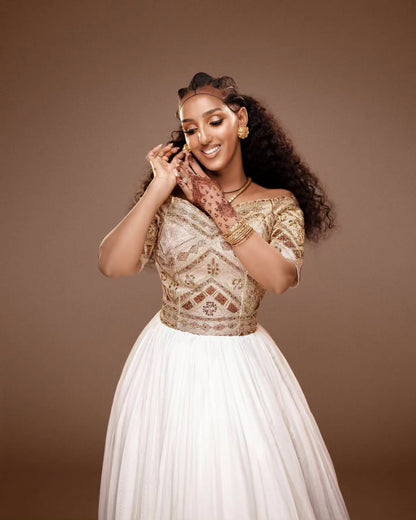 Woman wearing a traditional Habesha Kemis with a brown background