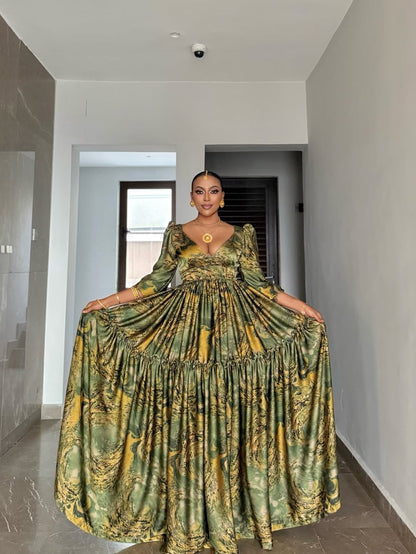 Woman wearing a green and gold patterned Green Flowing Habesha Shiffon Dress in an indoor setting