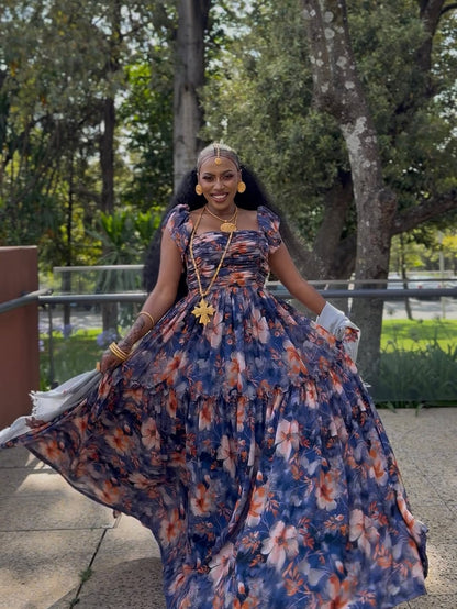 Woman in a Purple Habesha Shiffion standing outdoors with trees in the background