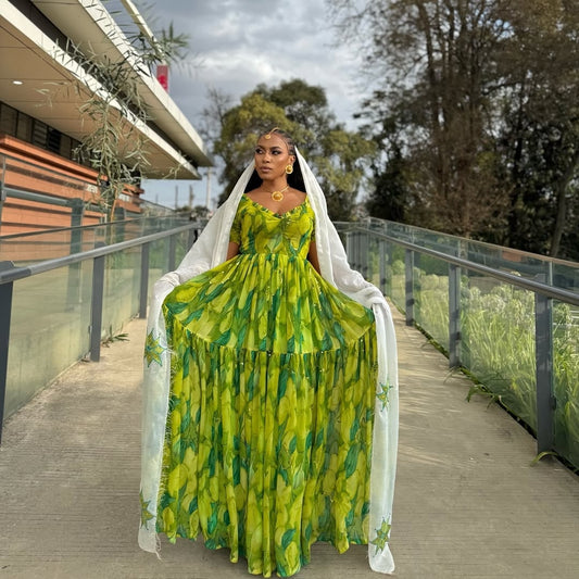 Woman in a Green Habesha Shiffion with a white scarf standing on a wooden bridge.