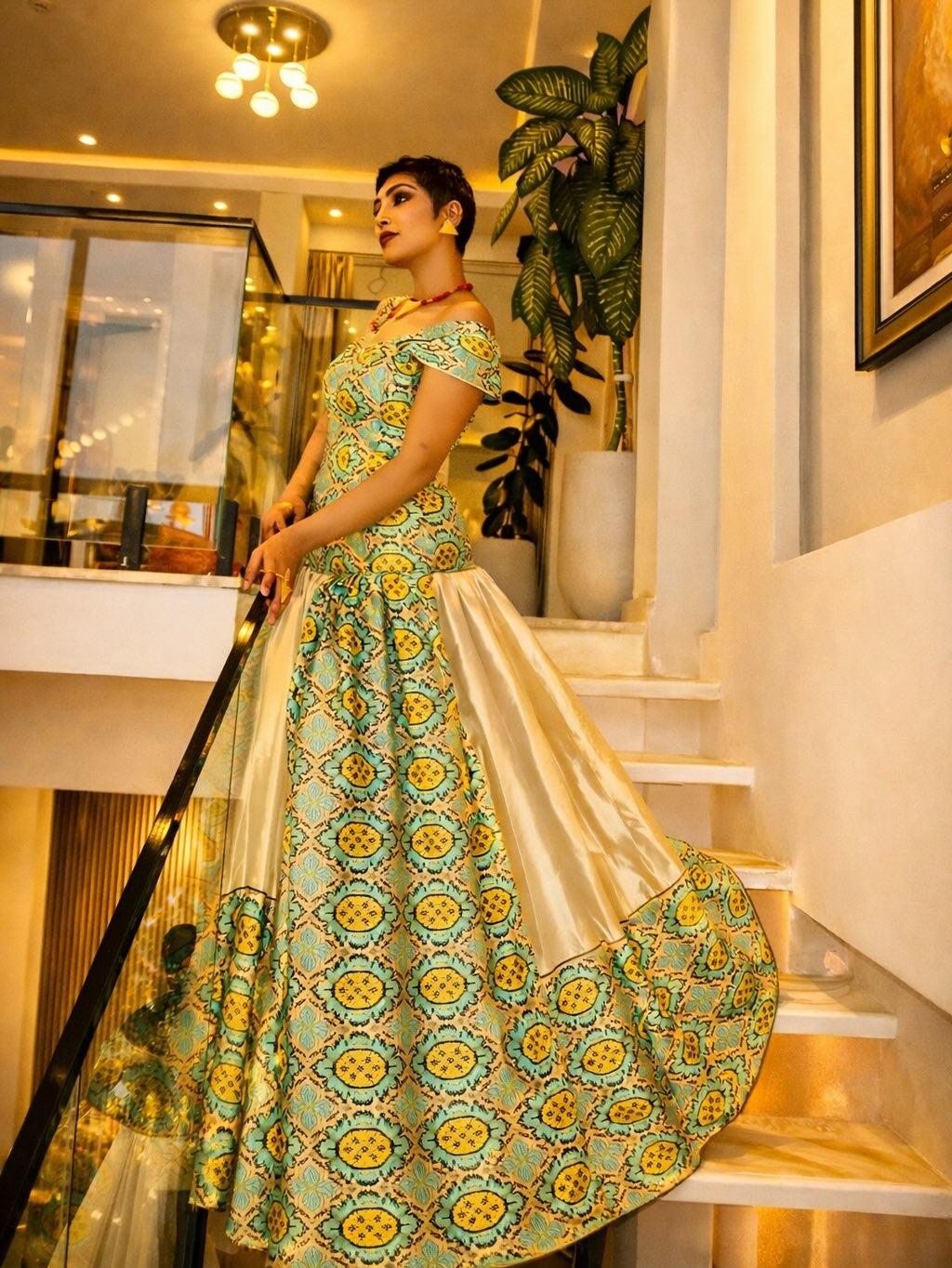 Woman in a green and yellow Habesha Libs patterned Habesha Libs standing indoors.