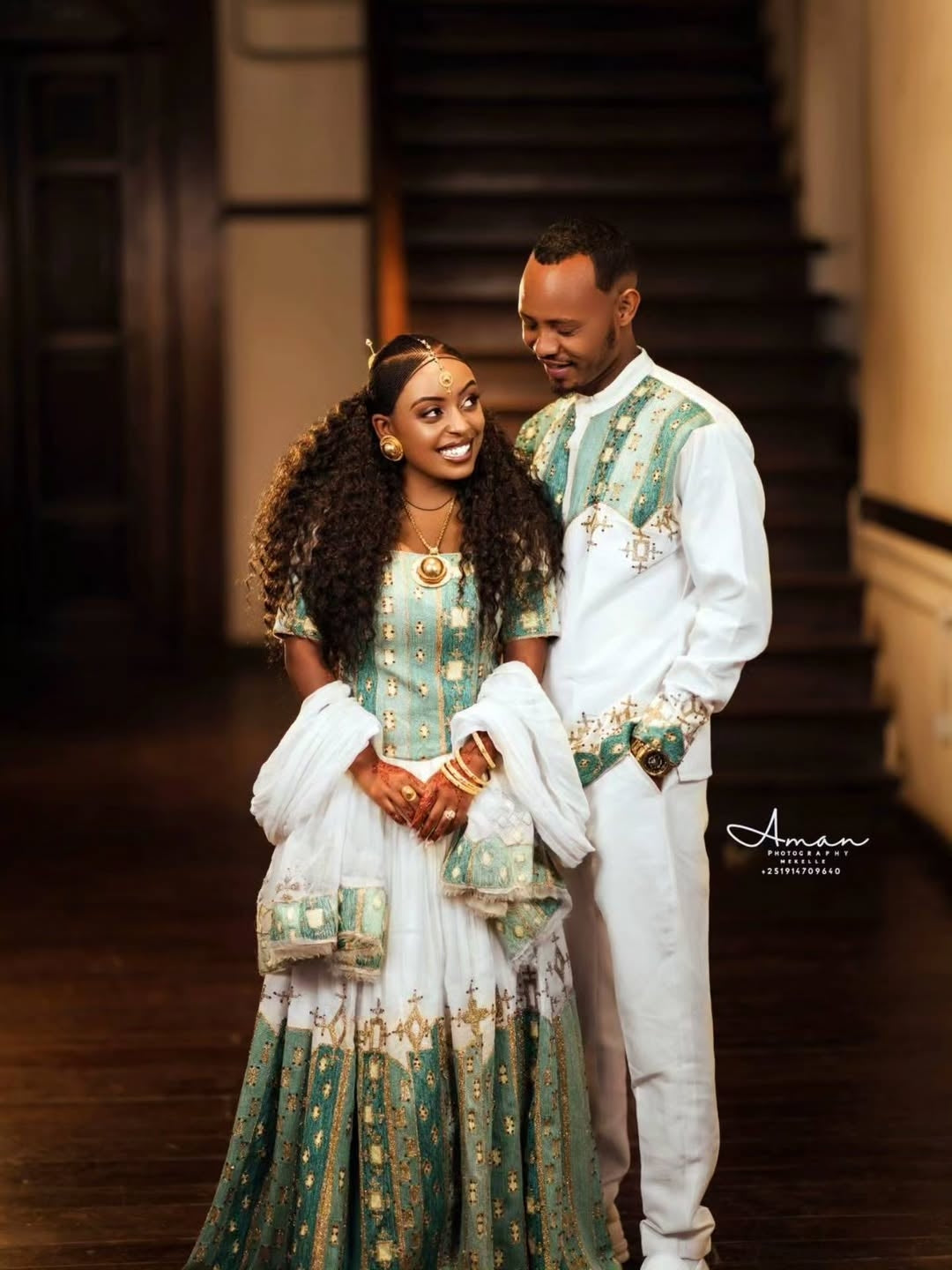 Couple in traditional attireGreen Ethiopian Couple Matching Set standing together indoors.