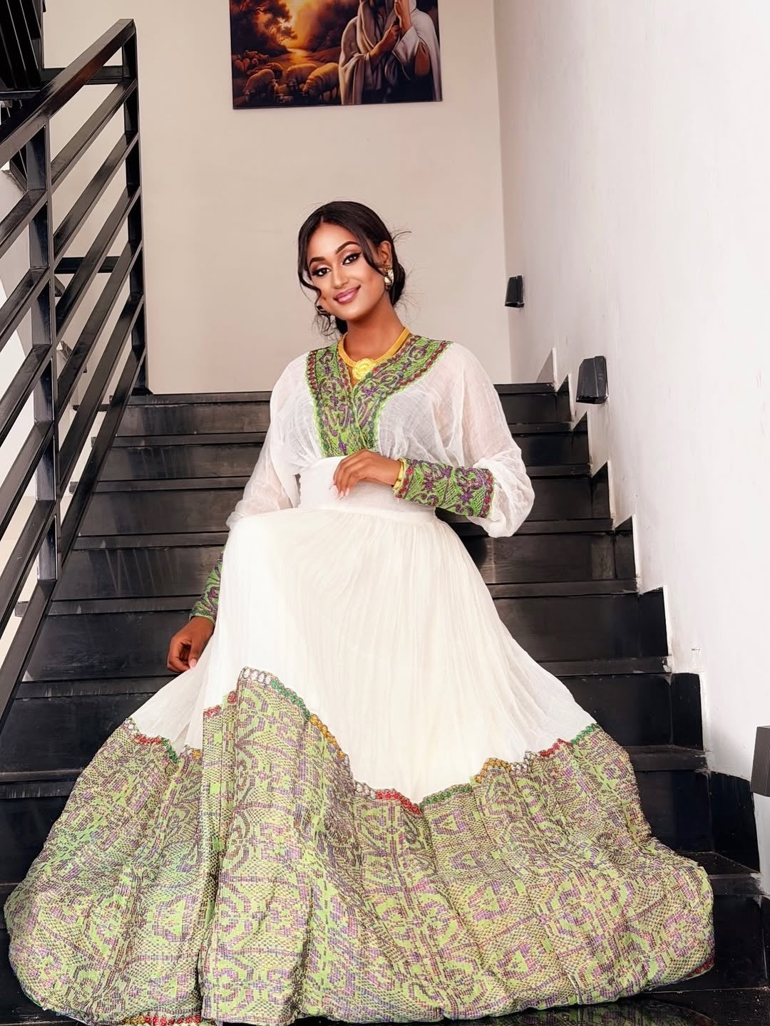 Woman in a traditional outfit sitting on a staircase