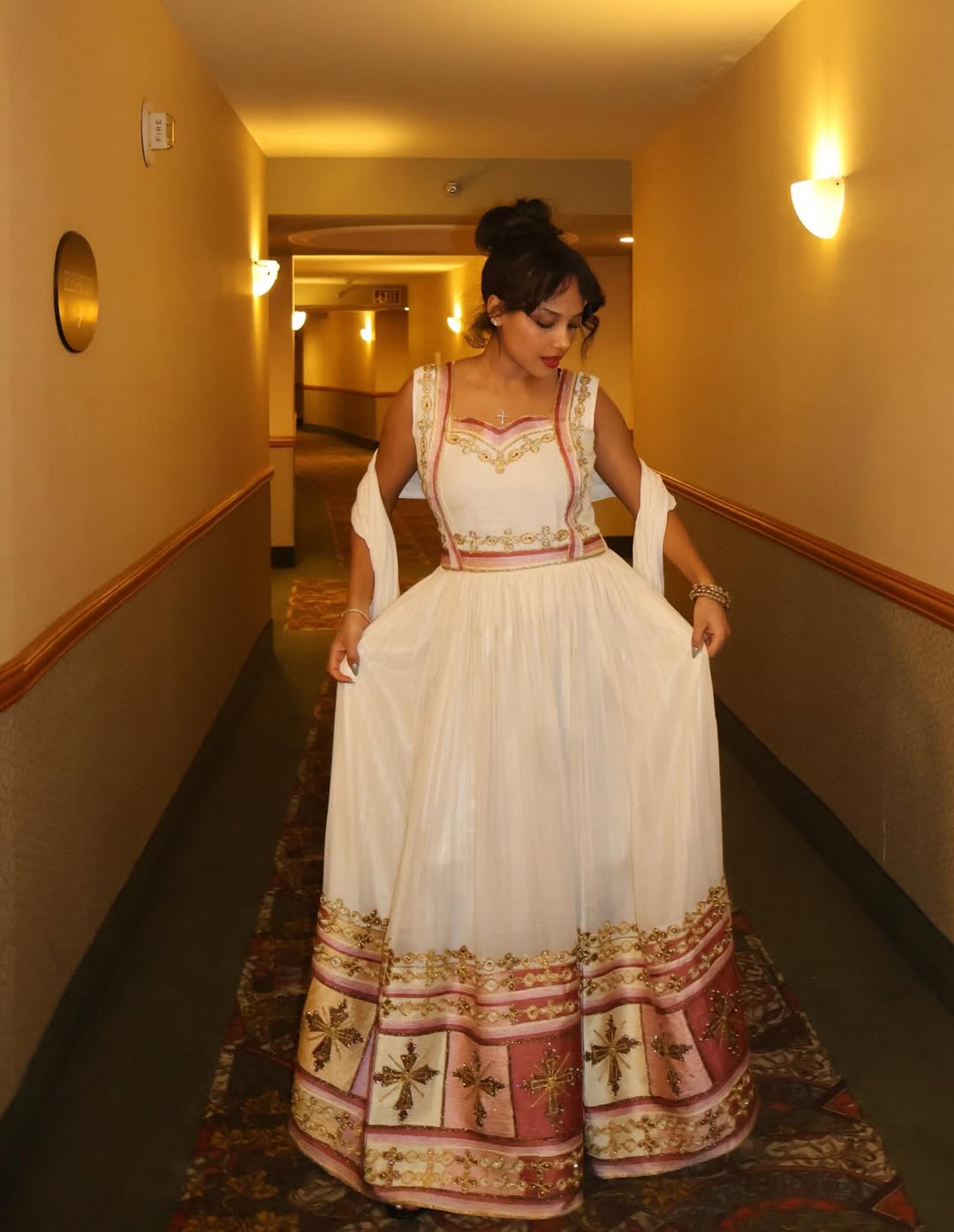 Woman in a Ethiopian traditional dress  standing in a hallway