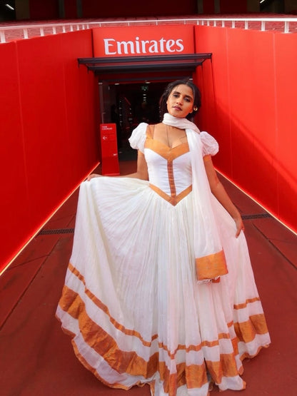 Golden-Trim Habesha Kemis – Chic Ethiopian White Dress with Handcrafted Netela Embroidery for Graduations, Engagements, and Wedding Celebrations