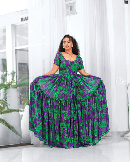 Woman wearing a green and purple Green Habesha Shifion  in a bright room.