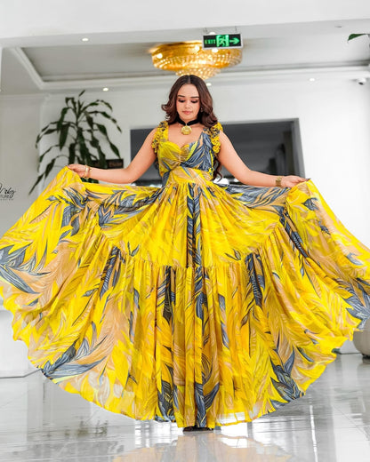 Woman in a yellow and black patterned Habesha Chiffon posing indoors.