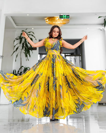 Woman in a yellow and blue patterned Habesha Chiffon posing in an indoor setting.
